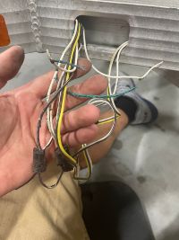 A man installing a trailer wire harness A man installing a trailer wire harness