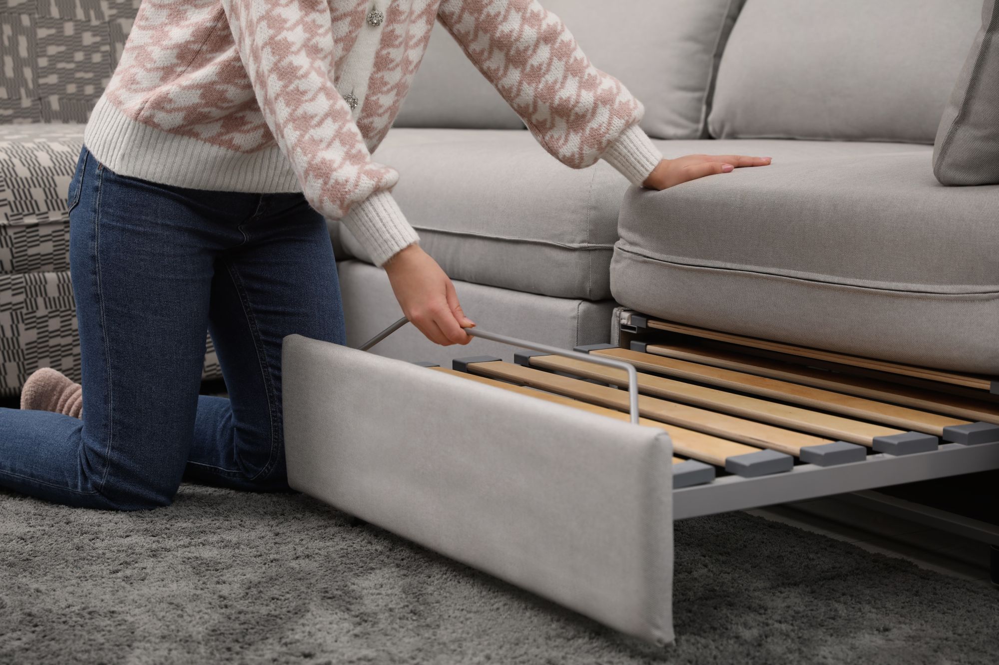 woman opening a sofa bed